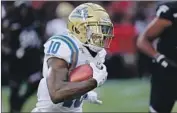  ?? Tony Tribble Associated Press ?? UCLA’s Demetric Felton Jr. is one of two running backs who will share the bulk of the carries.