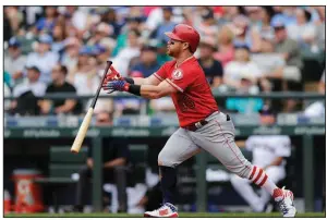  ?? AP/JOHN FROSCHAUER ?? Los Angeles Angels right fielder Kole Calhoun flips his bat on his follow through of a two-run home run Wednesday in the Angels’7-4 victory over Seattle.