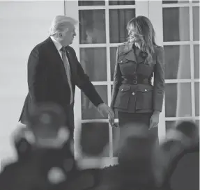  ?? EVAN VUCCI/AP ?? President Donald Trump stands with first lady Melania Trump after her speech to the Republican National Convention at the White House Tuesday.