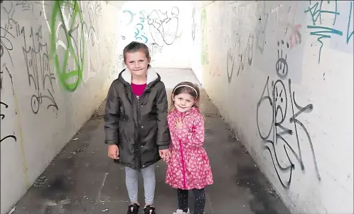  ??  ?? Sisters Sophia and Amayah Horton say they are “sad and upset” at the amount of graffiti blighting Canterbury