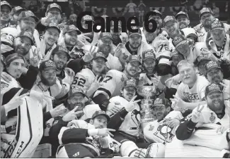  ?? Associated Press photo ?? Pittsburgh Penguins players celebrate after defeating the Nashville Predators 2-0 in Game 6 of the NHL hockey Stanley Cup Final, Sunday in Nashville, Tenn.