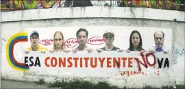  ?? WIL RIERA — THE ASSOCIATED PRESS ?? A poster shows some of Venezuela’s opposition leaders holding a sign with a message that reads in Spanish: “That constituen­t assembly will not pass” is displayed on a wall near Altamira Square in Caracas, Venezuela, on Thursday.