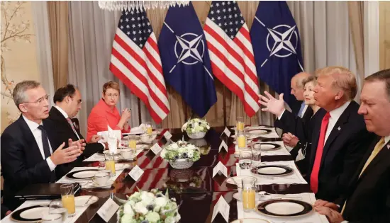  ??  ?? US President Donald Trump, right, and Nato Secretary General Jens Stoltenber­g, left, speaking during their bilateral breakfast yesterday in Brussels.