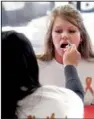  ?? Arkansas Democrat-gazette/
RICK MCFARLAND ?? Amber Church of Sherwood has her mouth swabbed by Nittara Lauland of Cabot during a bone-marrow drive at the Lakewood Village Shopping Park in North Little Rock on Sunday.
