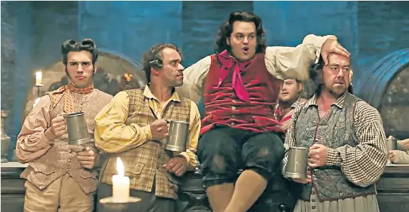  ??  ?? Flamboyant turn: manservant LeFou (centre), played by Josh Gad, sings an affectiona­te ditty for his master, Gaston, in the new version of Beauty and the Beast due in cinemas later this month