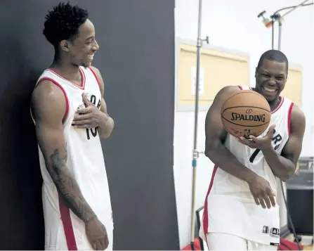  ?? CHRIS YOUNG/THE CANADIAN PRESS ?? Raptors DeMar DeRozan and Kyle Lowry share a joke as they pose for a photoshoot Monday during the team’s media day in Toronto.