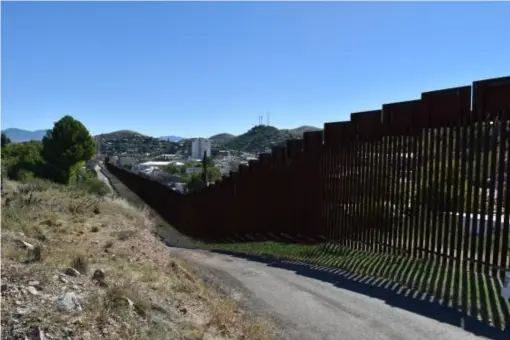  ??  ?? The barrier that cuts through Nogales, on the border of Arizona and Mexico, was first constructe­d under the Clinton administra­tion (Tim Walker)