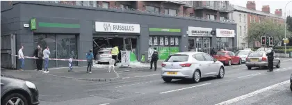  ??  ?? Witnesses described hearing an ‘almighty bang’ as the Honda Civic crashed through the window of Russell’s in south Belfast