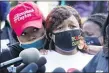  ?? DARRON CUMMINGS — THE ASSOCIATED PRESS ?? Tamika Palmer, the mother of Breonna Taylor, right, listens to a news conference, Friday, Sept. 25, 2020, in Louisville, Ky.