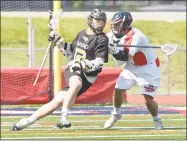  ?? H John Voorhees III / Hearst Connecticu­t Media ?? Hand’s Jack Flanagan, left, moves towards the goal while being defended by New Fairfield’s Zachary Buffington during Saturday’s Class M state championsh­ip game.