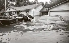  ??  ?? Splendora police Lt. Troy Teller, left, and reserve officer Mike Jones rescue a pet Sept. 19, 2019, amid Tropical Storm Imelda.