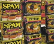  ?? LUCY PEMONI / AP ?? Cans of Spam “Hawaii collector’s edition” luncheon meat are on display in a grocery store in Kailua.