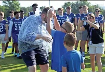  ?? / Spencer Lahr ?? Model fifth-grader Hayden Hollingswo­rth plops a plate of whipped cream onto the face of Assistant Principal Kyle Abernathy, as Principal Aimee Hays tries to capture the moment and second-grader Avery Gibson waits his turn.