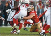  ?? RANDY VAZQUEZ — BAY AREA NEWS GROUP ?? The 49ers’ Nick Bosa tackles Arizona Cardinals’ Kenyan Drake in the fourth quarter on Sunday.