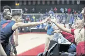  ?? ?? Dayton guard Koby Brea celebrates with fans after their upset win over Kansas on Friday in Lake Buena Vista, Fla.