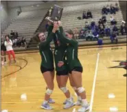  ?? NATE BARNES — THE NEWS-HERALD ?? Lake Catholic’s Ashley Browske, left, Katy Yopko and Kelsey Whalen accept the Division II Stow Regional championsh­ip trophy Nov. 3.
