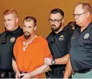  ?? [PHOTO BY
STEVE GOOCH, THE OKLAHOMAN] ?? Nathan LeForce is escorted into the Logan County Courthouse on April 20.