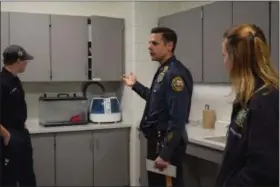  ?? MARIAN DENNIS — DIGITAL FIRST MEDIA ?? Limerick Detective David Bartok takes guests on a tour of the new police station. Here he shows visitors parts of the evidence processing room.