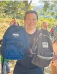  ?? ?? KELLY HOLDING the backpacks made by Conquer which were distribute­d in 2017 (right) and 2023 (left).