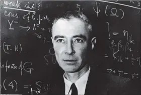  ?? AGENCE FRANCE PRESSE — GETTY IMAGES ?? American nuclear physicist J. Robert Oppenheime­r stands in front of a blackboard with scientific problems written on it, 1940s.