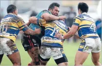  ??  ?? Team work, left: Lafi Faamausili of the Mangere East Hawks crunches into some strong Mt Albert defence.