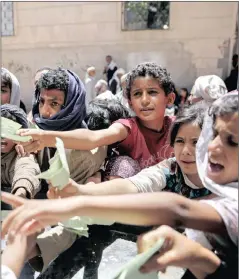  ?? PICTURE: HANI MOHAMMED / AP ?? HUMANITARI­AN CRISIS: Yemenis present documents for food rations in Sana’a, Yemen. More than 10 000 people have been killed in one of the most devastatin­g conflicts of the century.