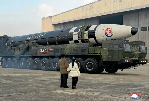  ?? AP ?? North Korean leader Kim Jong Un, left, and his daughter inspect what Pyongyang says is a Hwasong-17 interconti­nental ballistic missile at Pyongyang Internatio­nal Airport.