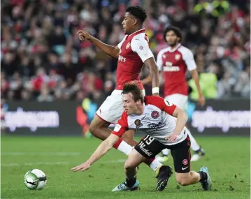  ??  ?? SYDNEY: Arsenal’s player Alex Iwobi (C) fights for the ball with Western Sydney’s player Jacob Melling during a friendly game in Sydney yesterday.—