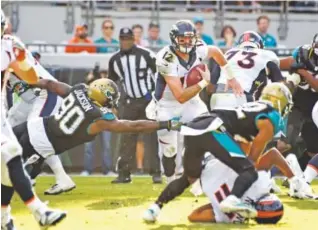  ??  ?? Broncos quarterbac­k Paxton Lynch tries to run against the Jaguars on Dec. 4 at EverBank Field in Jacksonvil­le, Fla. John Leyba, Denver Post file