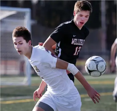  ?? NAncy LAne / HeRALd stAff fiLe ?? LEADER OF THE PACK: BC High’s Malcolm Flaherty, left, battles for the ball with Wellesley’s PJ Genta during the Div. 1 boys south final on Nov. 12, 2018.