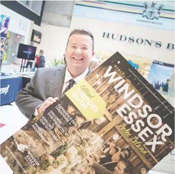  ?? DAX MELMER ?? Gordon Orr, CEO of Tourism Windsor Essex Pelee Island, displays the cover of the new Official Visitors Guide, which has plenty of informatio­n to help plan a spring or summer staycation.