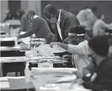  ?? Atlanta Journal-constituti­on/tns ?? Election workers in Fulton County during a recount of ballots in Atlanta, Georgia on Saturday, Nov. 14.