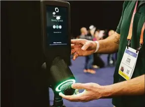  ?? Associated Press ?? An exhibitor demonstrat­es the OneThird avocado ripeness checker during CES Unveiled before the start of the CES tech show in Las Vegas. The device is designed for use by grocery store shoppers to scan an avocado and get informatio­n about when it is ready to eat.