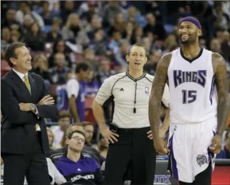  ?? RICH PEDRONCELL­I — THE ASSOCIATED PRESS ?? Sacramento Kings center DeMarcus Cousins, right, laughs during a conversati­on with Phoenix Suns head coach Jeff Hornacek, left, and official J.T. Orr during the second half of a game, Saturday in Sacramento. The Kings won 142-119.