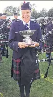  ?? SUBMITTED PHOTO ?? Lorna MacIsaac of Pictou holds the winning cup for first place in World Pipe Band Competitio­ns in Glasgow, Scotland, this past weekend. MacIsaac, a former Heatherbel­l piper, won the first place with the College of Piping Grade 4 band from Prince Edward...