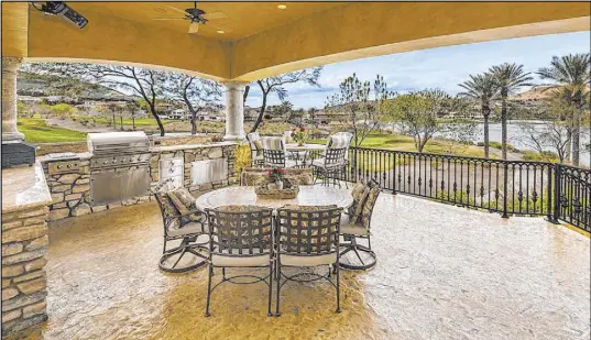  ??  ?? The Mediterran­ean-style mansion has balconies overlookin­g Lake Las Vegas and the golf course.
Elite Homes