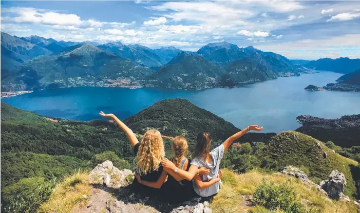  ??  ?? Rachel Janes, Maddie Dick and Caitlin McNamara at Lake Como, Italy, as part of the trio’s six-month journey through Europe.