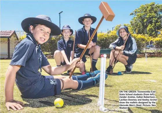 ?? ?? ON THE GREEN: Toowoomba East State School students (from left) Zander Anstiss, Kallan Robertson, Lachlan Downey and Keeley Archer show the mallets designed by the Glenvale Men’s Shed. Picture: Nev Madsen