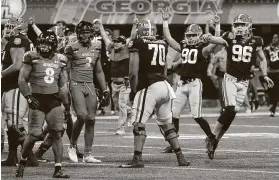  ?? Curtis Compton / Associated Press ?? Georgia kicker Jack Podlesny (96) reacts to his game-winning 53-yard field goal with three seconds remaining in the game to beat Cincinnati in the Peach Bowl.