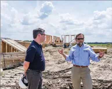  ??  ?? Roy Wright (left), president and CEO of the Insurance Institute for Business Home Safety, talks with Louisiana Office of Community Developmen­t Executive Director Pat Forbes on July 28 about the ongoing redevelopm­ent program at the New Isle community in Schriever, La.