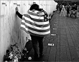  ?? GENE J. PUSKAR/AP ?? Chrissy Bortz pays respects at the Flight 93 memorial in Shanksvill­e, Pa., on Tuesday.