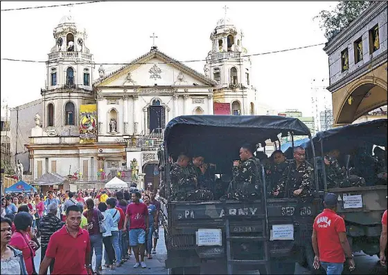  ?? MIKE AMOROSO ?? Army soldiers arrive at the Quiapo Church in Manila yesterday as part of security measures for the Black Nazarene feast.