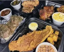  ??  ?? The menu at Mamma Lou's Soul Food Kitchen on Walzem Road includes, clockwise from front, fried catfish, oxtails, a smothered pork chop, fried chicken and baked chicken with sides like mac and cheese, fried okra, black-eyed peas, sweet potatoes and greens.