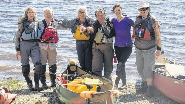  ?? SUE HUTCHINS PHOTOS ?? En route, the paddlers carried on a tradition of occasional­ly toasting the river with brandy, either by slugging a cap-full or throwing it over their shoulder. It was also a fitting way to end the journey. (From left: Marcy Wallace, Heather King,...