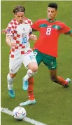  ?? AP-Yonhap ?? Croatia’s Luka Modric, left, and Morocco’s Azzedine Ounahi vie for the ball during the World Cup group F soccer match between Morocco and Croatia at the Al Bayt Stadium in Al Khor, Qatar, Wednesday.