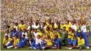  ?? Photograph: Action Images ?? Brazil celebrate winning their fourth World Cup after beating Italy on penalties in 1994. Ronaldo is second right in the front row, wearing Pierluigi Casiraghi’s shirt.
