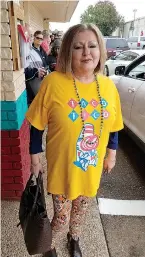  ?? Staff photo by Karl Richter ?? ■ Tyna Nix shows off her Taco Tico T-shirt during the grand opening of the restaurant chain’s newest location Thursday in Texarkana, Texas. Nix was among dozens in line waiting for the doors to open.