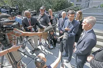  ?? Elaine Thompson/Associated Press ?? Washington Attorney General Bob Ferguson, third right, speaks with the media following a hearing where a federal judge issued a temporary restrainin­g order to stop the release of blueprints to make untraceabl­e 3D-printed plastic guns on Tuesday in...