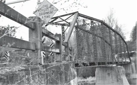  ?? [STEVE KANNON / THE OBSERVER] ?? Long closed, the old steel truss bridge on the Woolwich-Pilkington Townline, a boundary road with Centre-Wellington Township, has been earmarked for permanent closure and demolition in an engineerin­g report that will be considered by council.