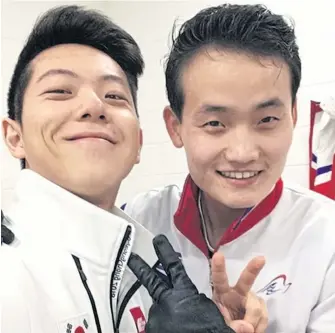  ?? AP ?? South Korean figure skater Kam Alex Kam Chang, left, and North Korean counterpar­t Kim Ju-sik pose for a selfie after training for the 2018 Winter Olympics.